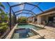 Gorgeous screened pool area with luxurious spa, inviting seating and well maintained backyard at 17936 Polo Trl, Bradenton, FL 34211