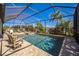 Sparkling screened pool and spa area surrounded by lush tropical foliage, perfect for relaxation at 17936 Polo Trl, Bradenton, FL 34211