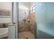 Walk-in shower featuring tiled walls, glass door and natural lighting at 17936 Polo Trl, Bradenton, FL 34211