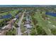 An aerial view of a home on a tree-lined street near the golf course at 650 Poinsettia Rd, Belleair, FL 33756