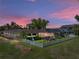 Lovely backyard featuring a large fenced in yard, beautiful landscaping, and a screened in porch for outdoor living at 650 Poinsettia Rd, Belleair, FL 33756