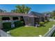 Home exterior with a screened patio and manicured lawn, offering a private outdoor space at 650 Poinsettia Rd, Belleair, FL 33756