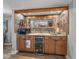 Stylish bar area with granite countertops, wine cooler, and modern fixtures at 650 Poinsettia Rd, Belleair, FL 33756