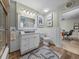 Bright bathroom featuring a white vanity, toilet, and nautical-themed decor at 650 Poinsettia Rd, Belleair, FL 33756