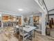 Open dining area with skylight, and breakfast bar with seating and modern light fixtures at 650 Poinsettia Rd, Belleair, FL 33756
