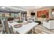 Bright dining area open to the living room with white furniture and decorative centerpiece at 650 Poinsettia Rd, Belleair, FL 33756