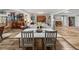 Open dining area with white table, chairs and hardwood floors, filled with natural light at 650 Poinsettia Rd, Belleair, FL 33756