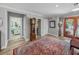 Welcoming foyer with hardwood floors, a vintage grandfather clock, and easy access to the bathroom at 650 Poinsettia Rd, Belleair, FL 33756