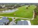 Scenic golf course view with pond, lush greens, and American flag at 650 Poinsettia Rd, Belleair, FL 33756