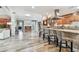 Bright eat-in kitchen features wood flooring, a granite counter and island seating at 650 Poinsettia Rd, Belleair, FL 33756