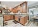 Spacious kitchen features wooden cabinets, granite counters, stainless appliances, and hardwood floors at 650 Poinsettia Rd, Belleair, FL 33756