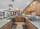 Open eat-in kitchen features granite countertops, stainless steel appliances and lots of storage at 650 Poinsettia Rd, Belleair, FL 33756