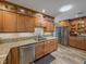 Beautiful kitchen with stainless steel refrigerator, granite countertops and wood cabinets at 650 Poinsettia Rd, Belleair, FL 33756