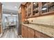 Well-lit kitchen showcasing granite counters, stainless steel appliances, and wooden cabinetry at 650 Poinsettia Rd, Belleair, FL 33756