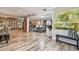 Spacious open-concept living room and dining area, featuring hardwood floors and neutral décor at 650 Poinsettia Rd, Belleair, FL 33756