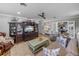 Comfortable living room featuring a plush sofa, tv, and view into an adjacent room through french doors at 650 Poinsettia Rd, Belleair, FL 33756