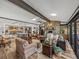 Large living room features a stone fireplace, hardwood floors, and an open floor plan concept at 650 Poinsettia Rd, Belleair, FL 33756