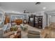 Cozy living room with comfortable seating, piano, and a decorative display unit with a tv at 650 Poinsettia Rd, Belleair, FL 33756