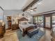 Spacious main bedroom featuring a walk-in closet, wood beams and private outdoor access at 650 Poinsettia Rd, Belleair, FL 33756