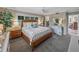Comfortable main bedroom featuring a bed with side tables and tropical decor at 650 Poinsettia Rd, Belleair, FL 33756