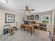 Home office with carpeted floors, ceiling fan, and a wooden desk with traditional legs at 650 Poinsettia Rd, Belleair, FL 33756