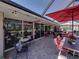 Spacious screened patio with brick pavers, ample seating, and elegant lighting for outdoor entertaining at 650 Poinsettia Rd, Belleair, FL 33756