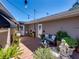 Charming patio with wooden deck, stylish seating, string lights, and lush plants at 650 Poinsettia Rd, Belleair, FL 33756