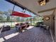 Well-appointed screened patio with dining set, comfortable seating, and outdoor decor at 650 Poinsettia Rd, Belleair, FL 33756