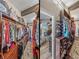 A large walk-in closet featuring custom shelving and storage with access to the main bedroom at 650 Poinsettia Rd, Belleair, FL 33756