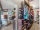 Spacious walk-in closet with custom shelving, shoe racks, and clothing storage with an open doorway to the room beyond at 650 Poinsettia Rd, Belleair, FL 33756