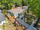 Aerial view of charming single-story house with mature trees, lush green lawn, and inviting curb appeal at 1206 E Hamilton Ave, Tampa, FL 33604