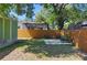 Large, fenced backyard with a patio and lush greenery provides a private retreat at 1206 E Hamilton Ave, Tampa, FL 33604