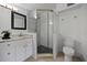 Contemporary bathroom with a sleek vanity, glass-enclosed shower, and modern fixtures at 1206 E Hamilton Ave, Tampa, FL 33604