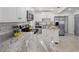 Well-lit kitchen features white cabinets, stainless steel appliances, and stylish countertops at 1206 E Hamilton Ave, Tampa, FL 33604