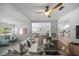 Bright and spacious living room featuring a modern ceiling fan and an open floor plan at 1206 E Hamilton Ave, Tampa, FL 33604
