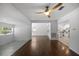 Expansive living room boasts wood floors, a ceiling fan, and ample natural light, creating a cozy atmosphere at 1206 E Hamilton Ave, Tampa, FL 33604
