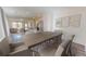 Open-concept dining room featuring wood floors, neutral paint, and modern decor with an oversized table and seating for six at 14725 Italy Ave, Dade City, FL 33523