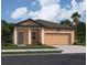 Charming single-story home with a two car garage, manicured lawn, and welcoming front entry at 14725 Italy Ave, Dade City, FL 33523