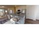 Eat-in kitchen island boasts barstool seating, granite countertops, and modern stainless steel appliances, connecting to the living room at 14725 Italy Ave, Dade City, FL 33523