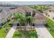 Expansive property showcases lush landscaping, a tile roof, and an inviting three-car driveway at 2709 Coco Palm Cir, Wesley Chapel, FL 33543