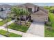 Spacious two-story home with a well-maintained lawn, three-car garage, and a tile roof at 2709 Coco Palm Cir, Wesley Chapel, FL 33543