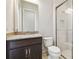 Bathroom with a granite vanity and tiled glass shower at 2709 Coco Palm Cir, Wesley Chapel, FL 33543