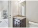 Half bathroom features granite vanity and door that leads to screened in patio at 2709 Coco Palm Cir, Wesley Chapel, FL 33543