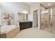 Bright bathroom featuring a soaking tub, granite counters, and glass enclosed shower at 2709 Coco Palm Cir, Wesley Chapel, FL 33543