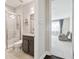 Bathroom view showcasing a glass shower enclosure, granite vanity top, and an adjacent bedroom at 2709 Coco Palm Cir, Wesley Chapel, FL 33543
