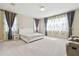 The bedroom features a light-colored carpet, curtains, and a white upholstered bed frame at 2709 Coco Palm Cir, Wesley Chapel, FL 33543
