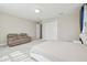 Bedroom featuring a plush, comfortable recliner, a white bedframe, and a built-in closet at 2709 Coco Palm Cir, Wesley Chapel, FL 33543