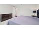 Bedroom featuring a dark-wood dresser with light grey walls and carpeted floors at 2709 Coco Palm Cir, Wesley Chapel, FL 33543