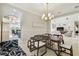 Open dining area with stylish furniture, contemporary lighting, and seamless flow to the living room at 2709 Coco Palm Cir, Wesley Chapel, FL 33543
