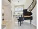 Grand foyer with soaring ceilings, sleek marble floors, a baby grand piano, and elegant staircase at 2709 Coco Palm Cir, Wesley Chapel, FL 33543